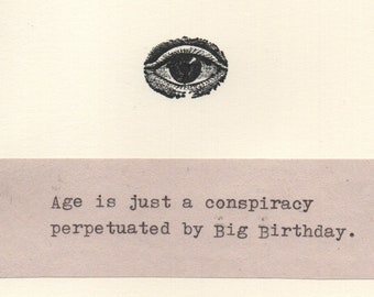 May include: A black and white illustration of an eye with the text "Age is just a conspiracy perpetuated by Big Birthday."