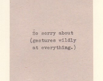 May include: A close-up of a piece of paper with the text "So sorry about (gestures wildly at everything.)" printed on it.