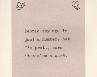 May include: A black and white image with a handwritten quote that reads: "People say age is just a number, but I'm pretty sure it's also a word."