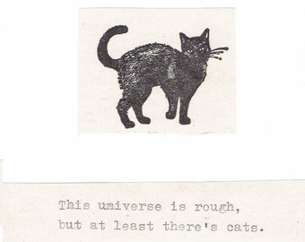 May include: Black and white illustration of a cat with the text "This universe is rough, but at least there's cats."