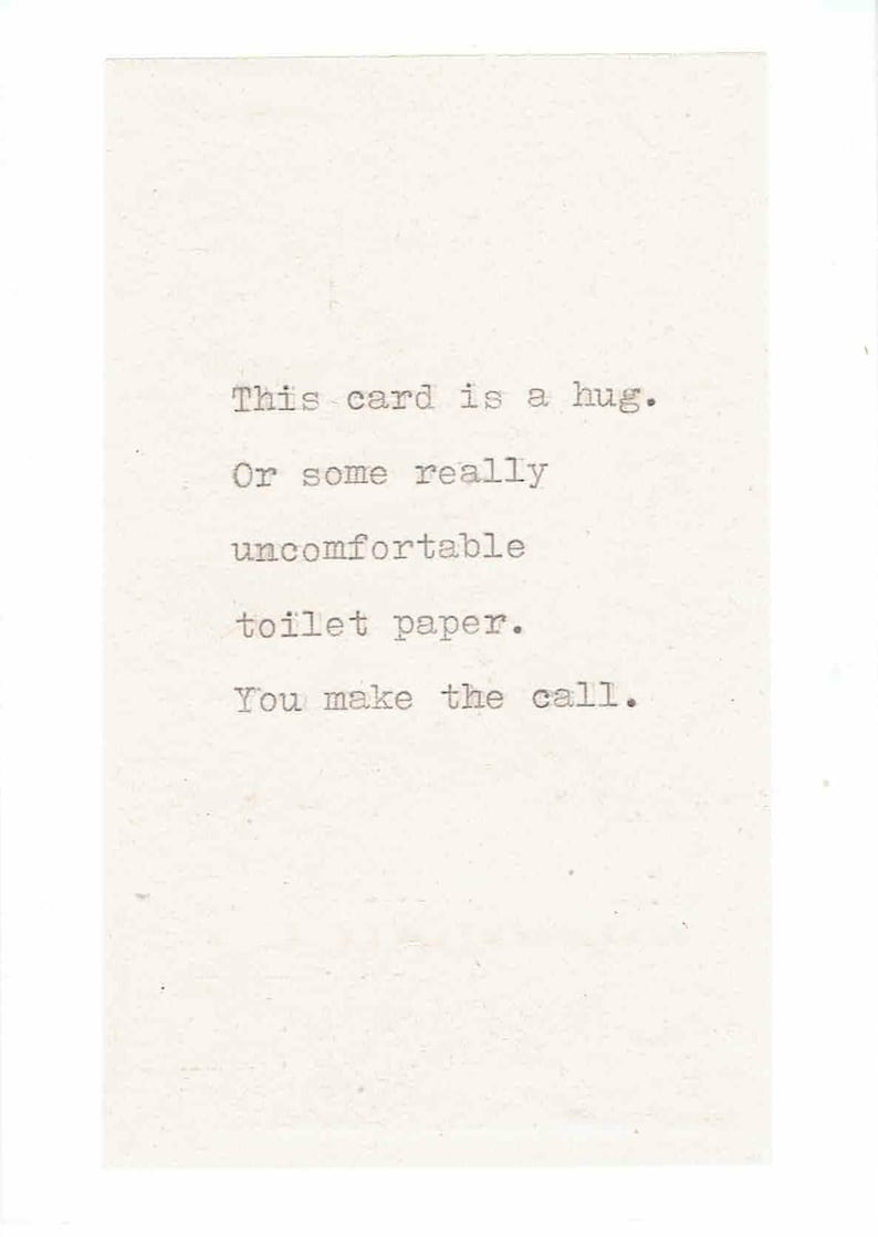 May include: A card with a humorous message that reads: "This card is a hug. Or some really uncomfortable toilet paper. You make the call."