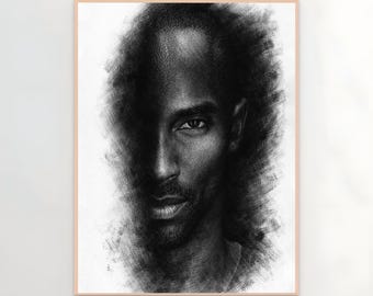 May include: A framed black and white pencil portrait of a person. The portrait is a close-up of the person's face, with one side of the face in shadow. The person has short hair and a beard.