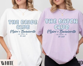 May include: White and lavender t-shirts with the text "THE BRIDE CLUB" and "THE BACH CLUB" in blue bubble letters. The text "Claire's Bachelorette, Las Vegas, NV, Est. 2025" is below the main text.