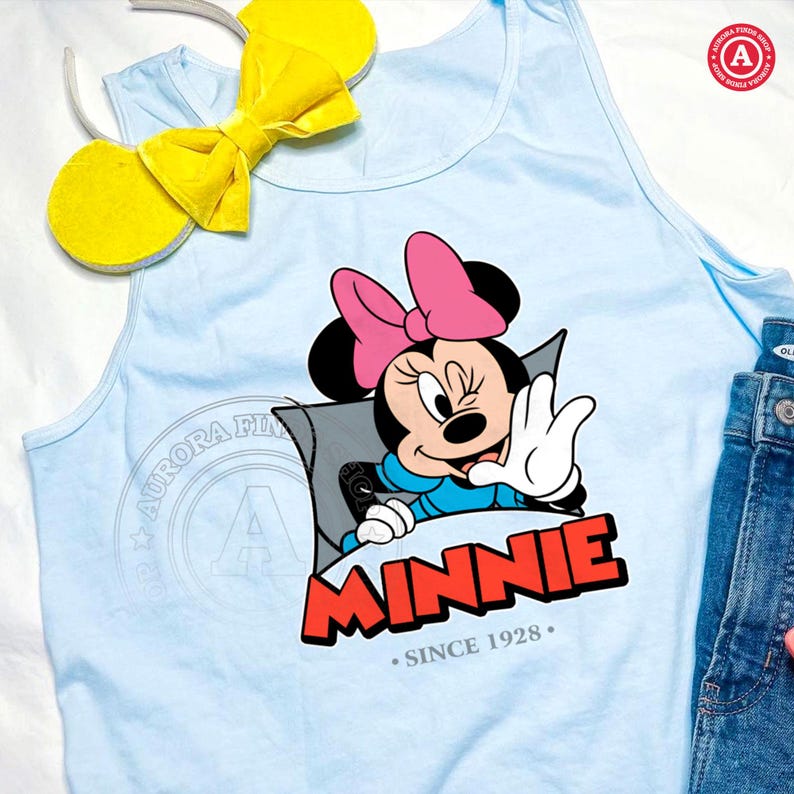 May include: Light blue tank top featuring a Minnie Mouse graphic with a pink bow and the word "MINNIE" in red. Includes a pair of yellow mouse ears on a headband. The text "SINCE 1928" is also present.