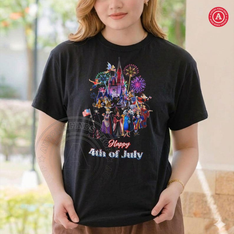 May include: Black t-shirt featuring a colorful graphic of a castle, fireworks, and various characters. The text "Happy 4th of July" is displayed below the graphic. The design includes an American flag.