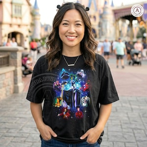 May include: Black t-shirt with a vibrant graphic showcasing Disney villains, including Maleficent and Cruella de Vil. The design features a starry backdrop and a collection of iconic characters. The shirt has a crew neck and short sleeves.