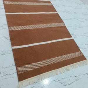 Rug placed in a living room setting with furniture for size and style reference.