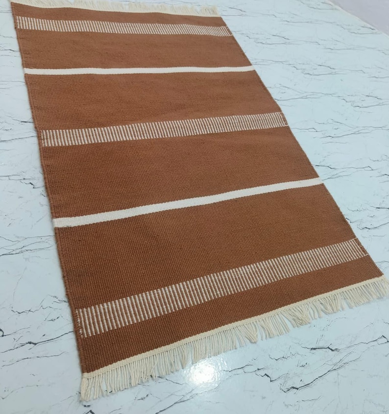 Rug placed in a living room setting with furniture for size and style reference.
