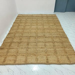 Close-up of the jute rug texture showing thick checkered weave and natural fibers.