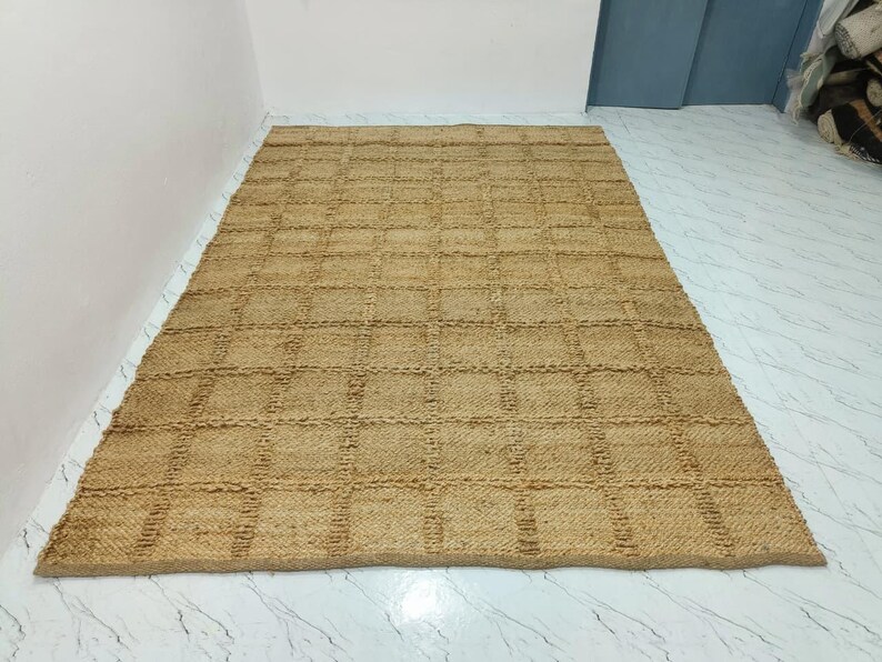 Close-up of the jute rug texture showing thick checkered weave and natural fibers.