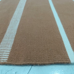 Folded rug showing flexibility and soft polypropylene fibers.