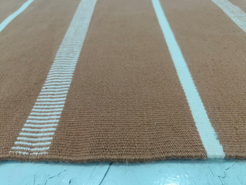 Folded rug showing flexibility and soft polypropylene fibers.