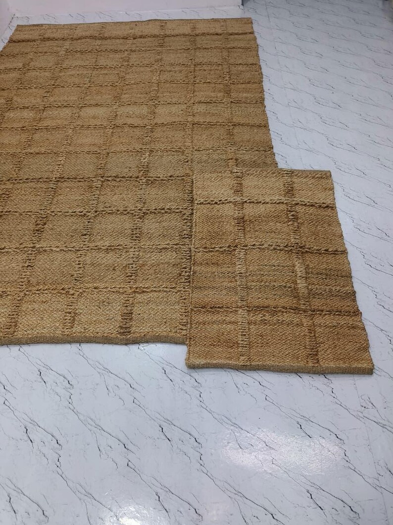 Overhead view of the checkered jute rug laid flat showcasing pattern details.
