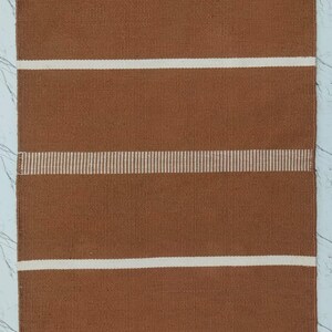 Close-up of the brown striped pattern showing texture and weave details.
