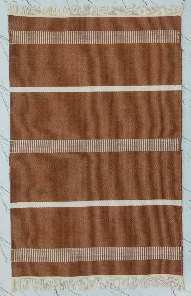 Close-up of the brown striped pattern showing texture and weave details.