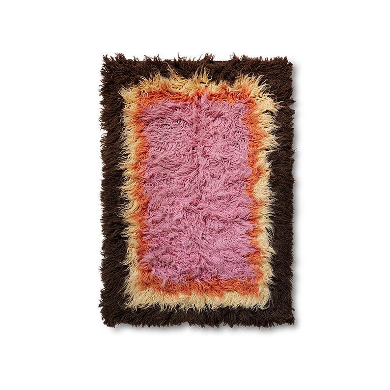 May include: A rectangular shag rug featuring a concentric layered design. The center is a solid pink, surrounded by a border of orange, followed by a border of cream, and finished with a thick, dark brown outer edge of long, shaggy fibers.