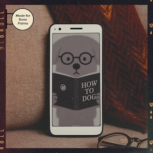 May include: A white smartphone case with a black border. The case features a cartoon illustration of a dog wearing glasses and reading a book titled "How to Dog".