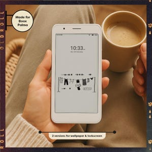 May include: A white e-reader displays a minimalist black and white illustration of clothes hanging on a clothesline. The screen shows the time as 10:33 AM, Nov 09 Saturday. The e-reader is held in a person's hand, with a coffee mug in the background.