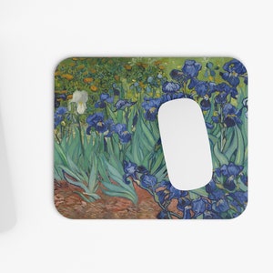 May include: A mouse pad featuring a painting of a field of blue and white irises with green leaves. The painting is in a style reminiscent of Vincent van Gogh.
