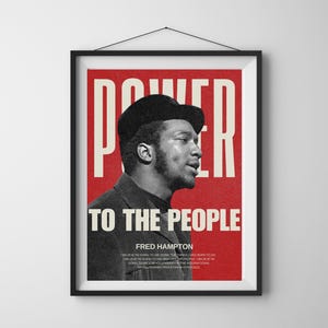 Black frame Fred Hampton poster hanging on a white wall. A striking civil rights leader tribute print, symbolizing revolutionary activism and empowerment.