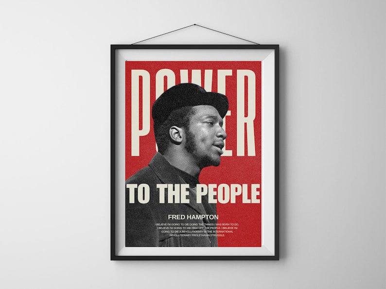 Black frame Fred Hampton poster hanging on a white wall. A striking civil rights leader tribute print, symbolizing revolutionary activism and empowerment.