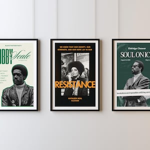 May include: Three framed posters with black frames hang on a white wall. The posters feature images of historical figures and text. One poster reads "Bobby Seale" with text about solidarity. Another says "Resistance" with a photo. The third says "Soul on Ice".