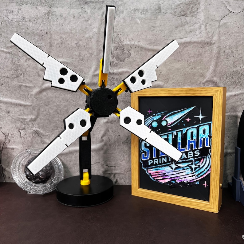 Death Stranding inspired 3D printed folding LED lamp designed with industrial aesthetics, featuring adjustable arms and joints for customizable lighting angles. This USB powered lamp combines futuristic tech-inspired design with practicality, making it perfect for both gamers and collectors. The lamp is made from durable PLA plastic, ensuring long-lasting use. The unique yellow, black, and metallic silver color scheme reflects the Bridges aesthetic from the popular video game