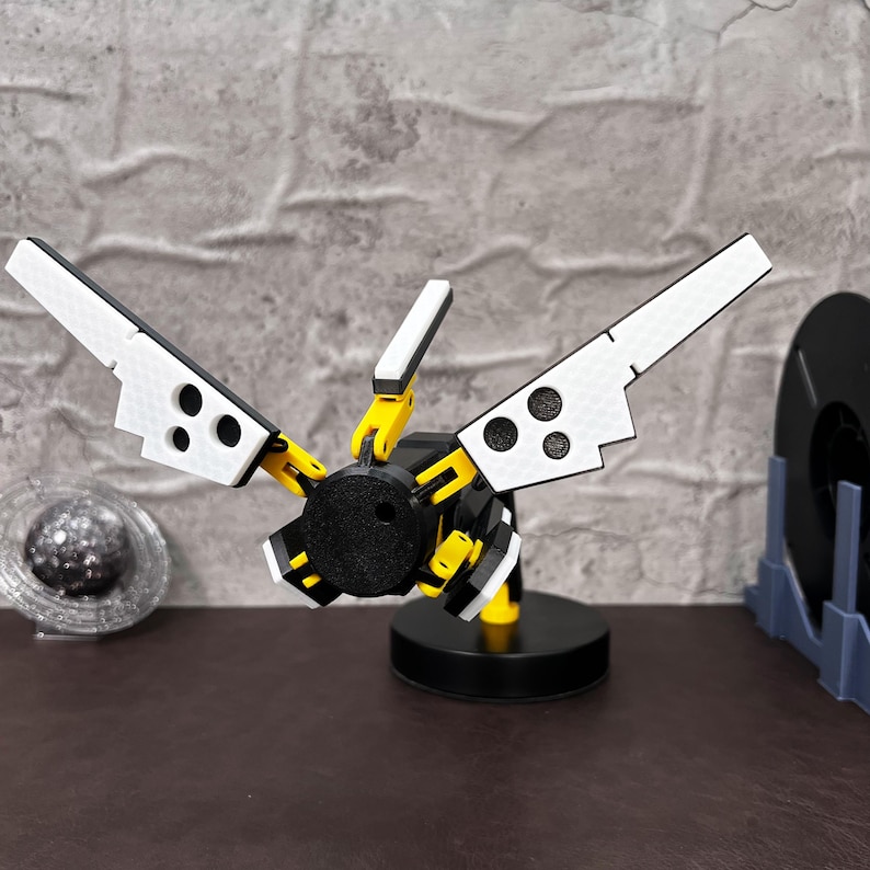 Death Stranding inspired 3D printed folding LED lamp designed with industrial aesthetics, featuring adjustable arms and joints for customizable lighting angles. This USB powered lamp combines futuristic tech-inspired design with practicality, making it perfect for both gamers and collectors. The lamp is made from durable PLA plastic, ensuring long-lasting use. The unique yellow, black, and metallic silver color scheme reflects the Bridges aesthetic from the popular video game