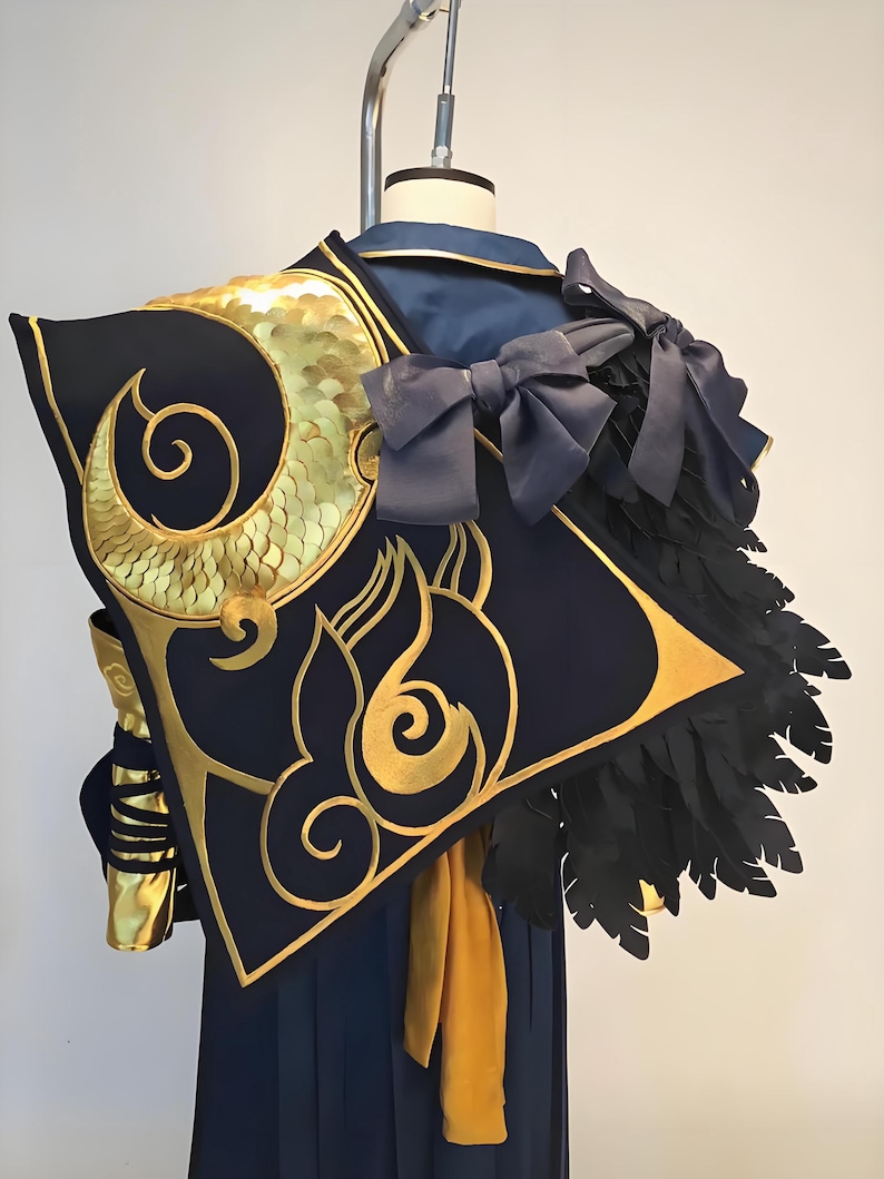 May include: A navy blue and gold cosplay costume with intricate detailing. The costume features gold embellishments, a black feather accent, and a large bow. The design includes a stylized golden spiral and flame motif.