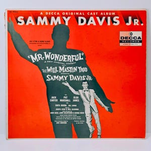 May include: Vintage album cover for "Mr. Wonderful" starring Sammy Davis Jr. The cover is predominantly red with a silhouette of a man and a smaller image of Sammy Davis Jr. in a suit. The album is a Decca Records original cast album.