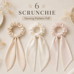 May include: Three satin hair scrunchies with long ribbon tails in shades of cream and pale pink. The text 6 SCRUNCHIE Sewing Pattern Pdf is centered at the top. The scrunchies feature a gathered fabric design with smooth, shiny surfaces.