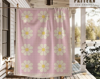 May include: A crochet pattern for a pink blanket with white daisy flowers. The pattern is called "C2C Crochet".