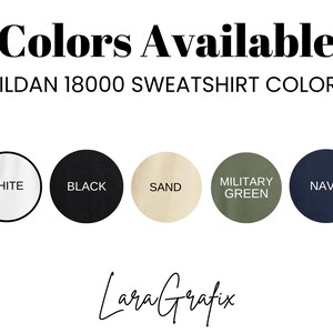 May include: Image displaying a selection of Gildan 18000 sweatshirt colors. The colors shown are white, black, sand, military green, and navy. The text "Colors Available" is at the top, with the brand name and logo at the bottom.
