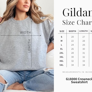 May include: A light gray Gildan G18000 crewneck sweatshirt. The image includes a size chart with measurements in inches for sizes S to 5XL. The chart details width, length, and sleeve measurements. The model is wearing the sweatshirt.