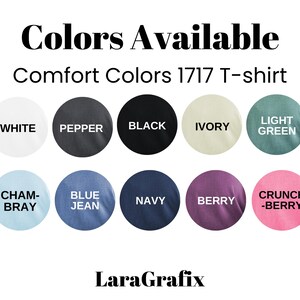 May include: An image displaying a color chart for Comfort Colors 1717 T-shirts. The chart features circles with the following colors: white, pepper, black, ivory, light green, chambray, blue jean, navy, berry, and crunch-berry. The text "Colors Available" and "LaraGrafix" are also present.