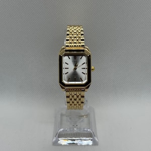 Vintage women’s gold rectangular watch, minimalist silver dial, gold link bracelet, elegant 90s retro quartz watch