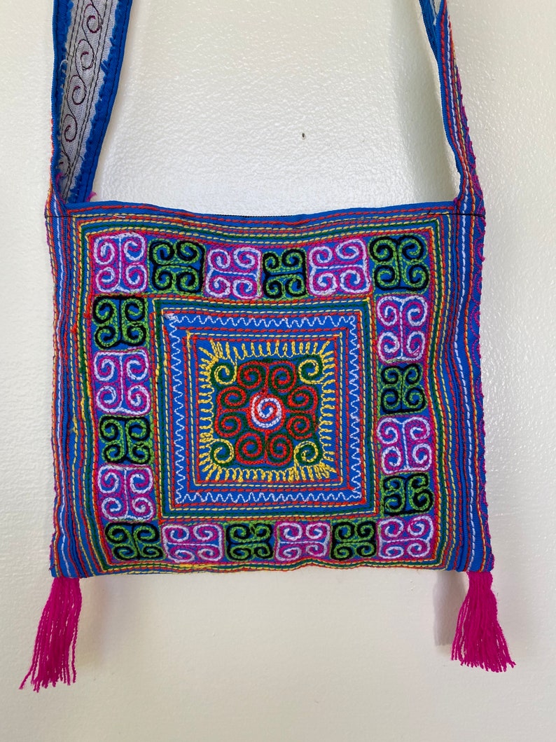 Thai embroidered cross body purse with zipper and fringe pink and blue colorful stitching zipper closure