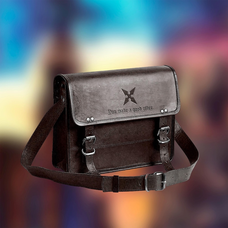 May include: A brown leather messenger bag with a black star and the text "You make a good other."