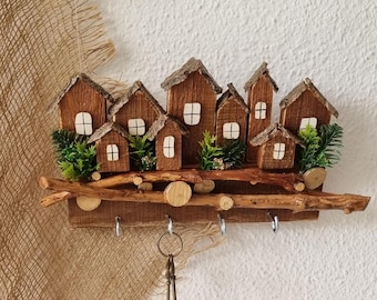 This unique country-style key holder "Village" is crafted from wood, bark,driftwood, and artificial plants. A gift with a country-house feel