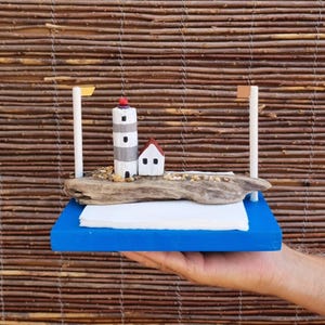 The original napkin holder in a marine style is made of wood and driftwood. Easy to use. A great gift for yourself and your loved ones.