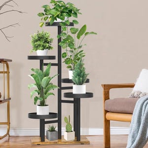 May include: A multi-level black metal plant stand displaying several potted plants. The stand features a wooden base and holds various green plants in white pots, creating a vertical garden. Suitable for indoor or outdoor use, it measures approximately 150 cm in height.