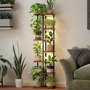 May include: A vertical plant stand with multiple shelves, displaying a variety of potted plants. The stand features a black metal frame and wooden shelves. The plants showcase diverse green foliage. The stand is lit with warm lighting, creating a welcoming ambiance.