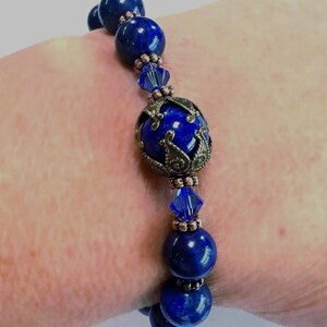 a lapis bracelet shown on a women’s wrist
