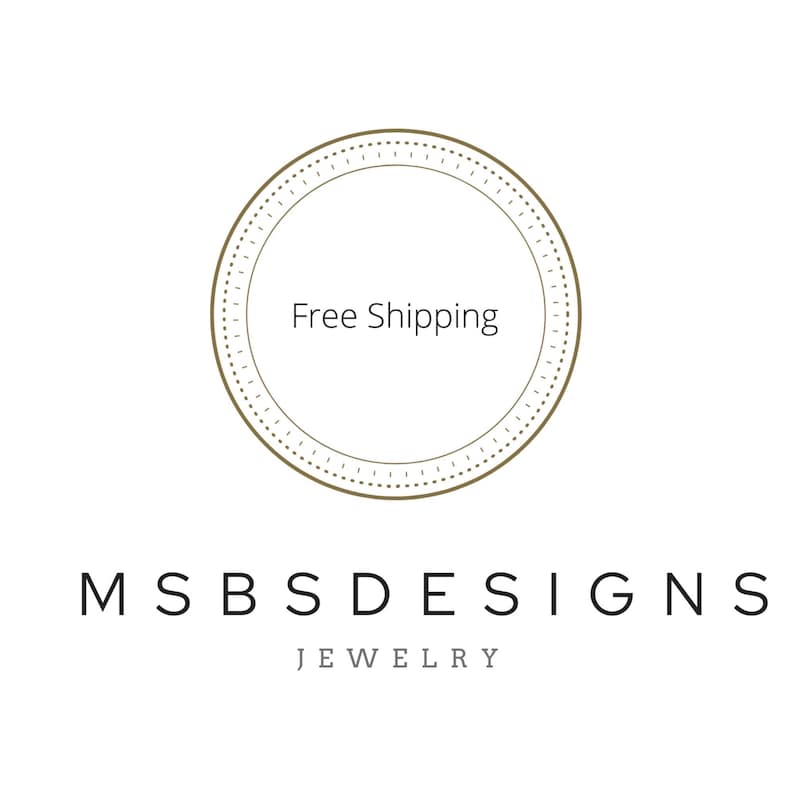 May include: A circular logo featuring a thin brown outline with a dashed inner border. The text Free Shipping is centered inside the circle. Below the circle, the text MSBS DESIGNS is printed in black, followed by the word JEWELRY in gray.