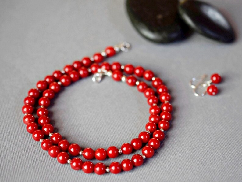 handmade beaded red coral necklace with small sterling silver beads. Includes matching coral earrings.  6mm round smooth real coral stones.