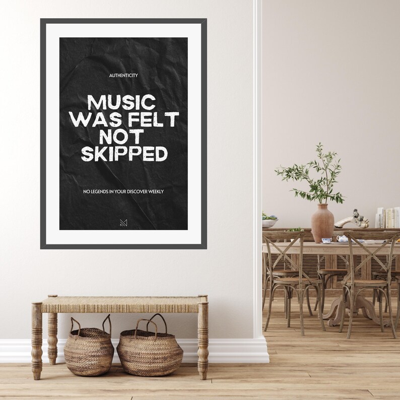 May include: Black and white poster with the text "Music was felt not skipped" and "No legends in your discover weekly". The poster has a crumpled paper texture and is framed in a black frame.