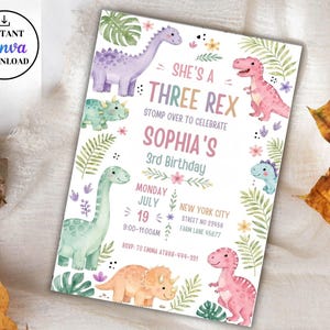 May include: A rectangular birthday invitation card featuring watercolor illustrations of various dinosaurs, tropical leaves, and flowers. The text reads: SHE'S A THREE REX, STOMP OVER TO CELEBRATE, SOPHIA'S 3rd BIRTHDAY, MONDAY JULY 19, NEW YORK CITY, STREET NO 23456, FARM LANE 45677, RSVP: TO EMMA AT 888-444-991.