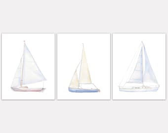 May include: Three watercolour paintings of sailboats. Each sailboat is a different size and has a different colour scheme. The sailboats are all white with blue and brown accents.