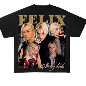 May include: Black t-shirt with a vintage-style graphic featuring multiple images of a person with blonde hair. The text "FELIX Stray Kids" is printed in gold on the shirt.