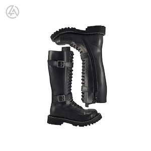 May include: Black knee-high boots with a rugged, treaded sole. The boots feature a lace-up front, side zipper, and two buckle straps. The leather boots are displayed against a white background.
